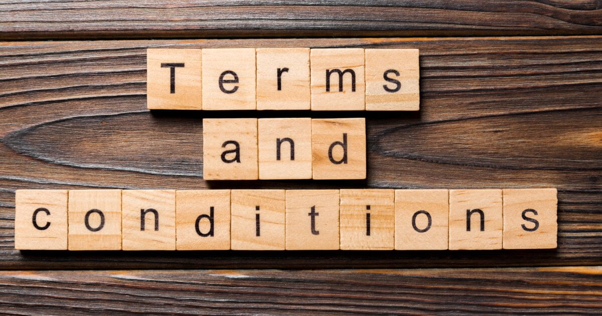 Image of wood block letters for Terms and Conditions on a darker wooden bench.